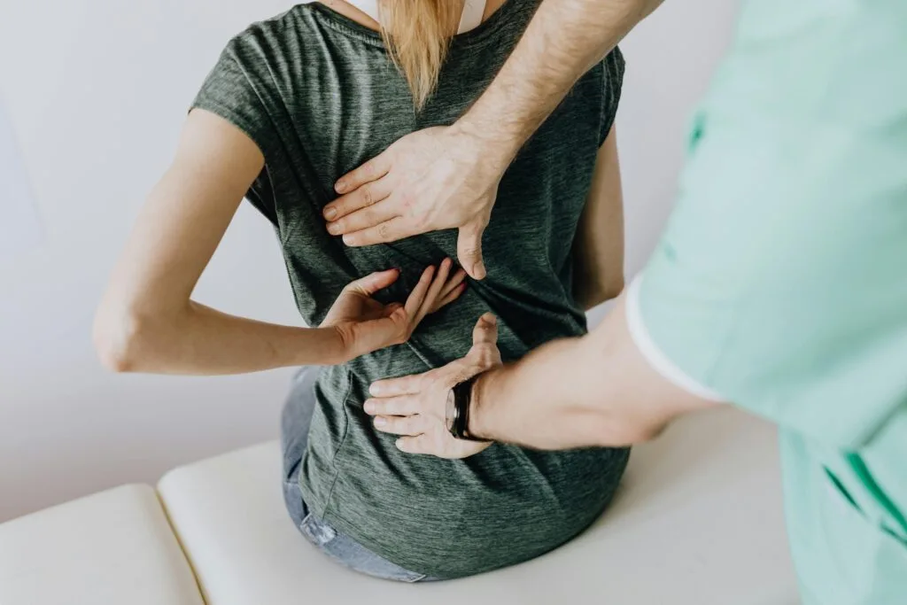 pexels-photo-4506109-4506109 A chiropractor examining a patient's back to alleviate pain and discomfort.